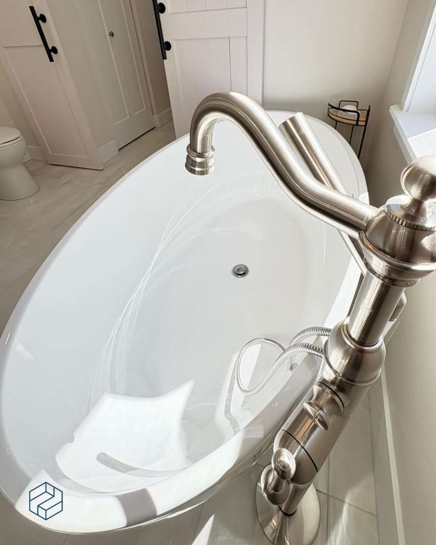 Detail of the brushed-nickel tub filler and hand shower at the freestanding tub.
