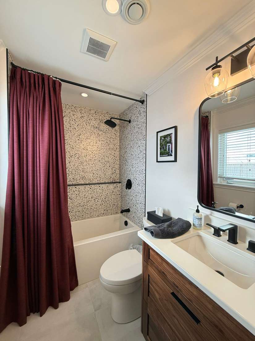 The finished Glenlonan Ensuite — speckled terrazzo tile and walnut vanity.