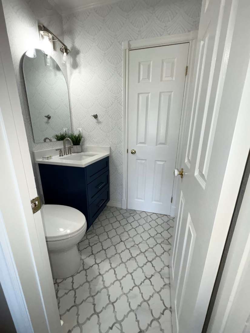 Kensington powder room — vanity and arabesque tile at floor level.