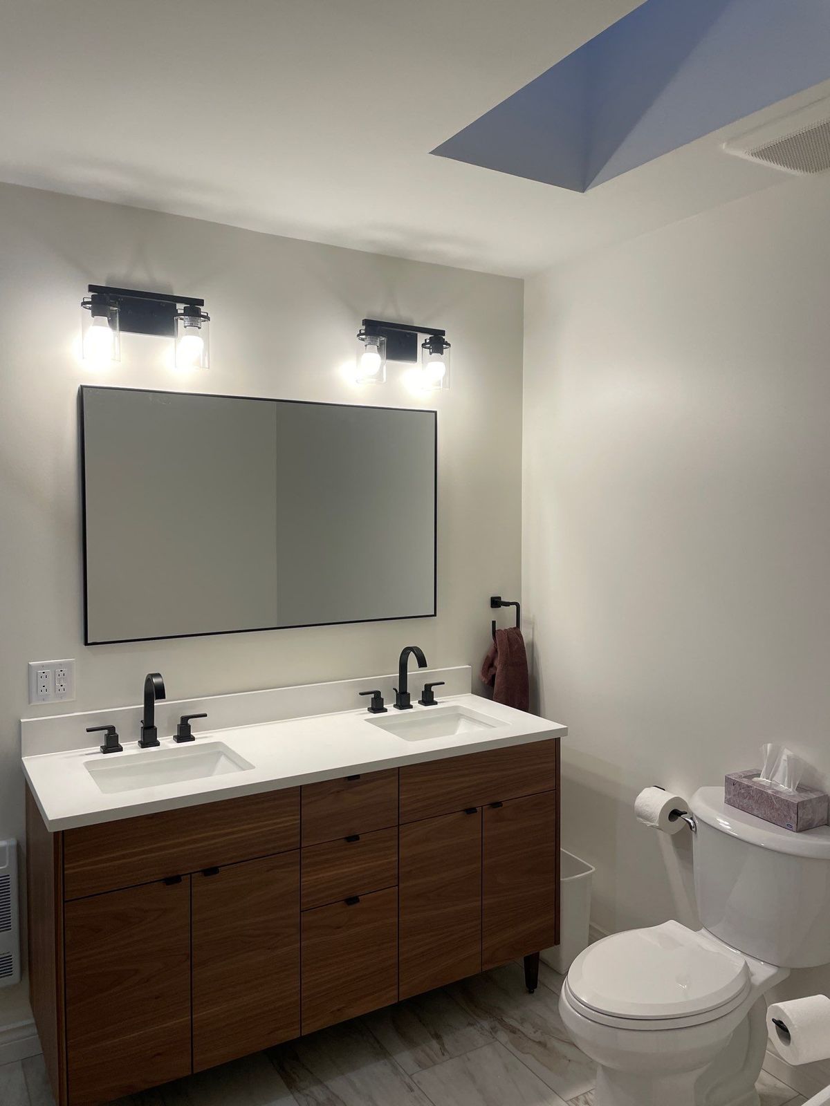 Baker Street double vanity with matte black fixtures and walnut cabinetry.