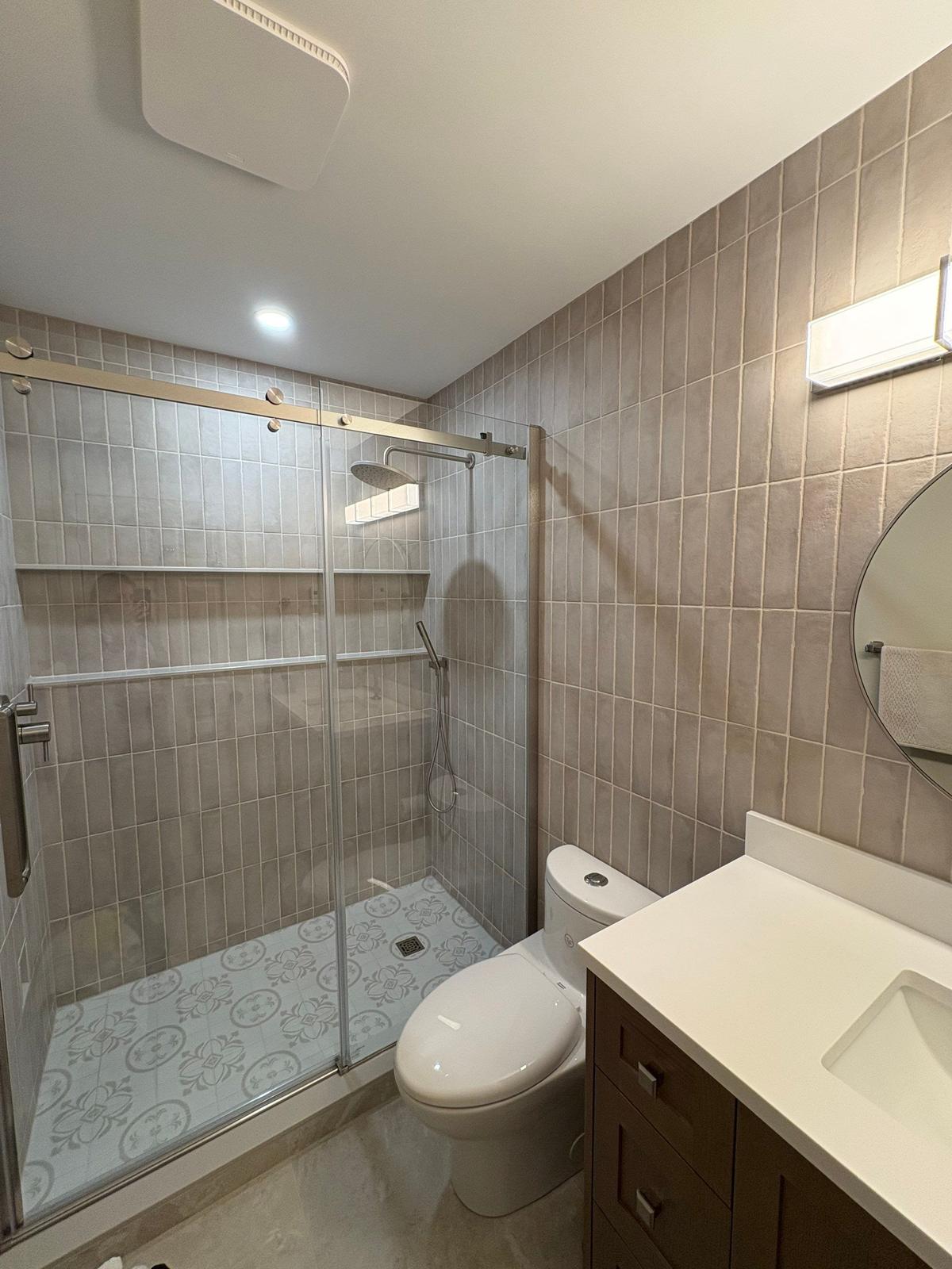 Ranger Avenue — finished glass shower and patterned tile floor.